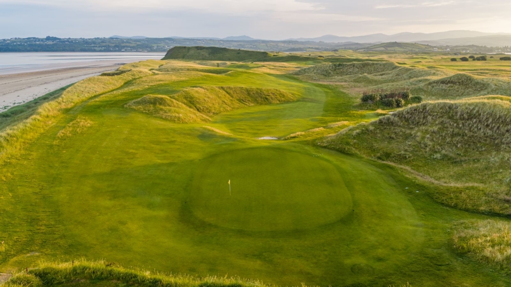 the course at donegal golf club surrounded by a beautiful beach and green hills