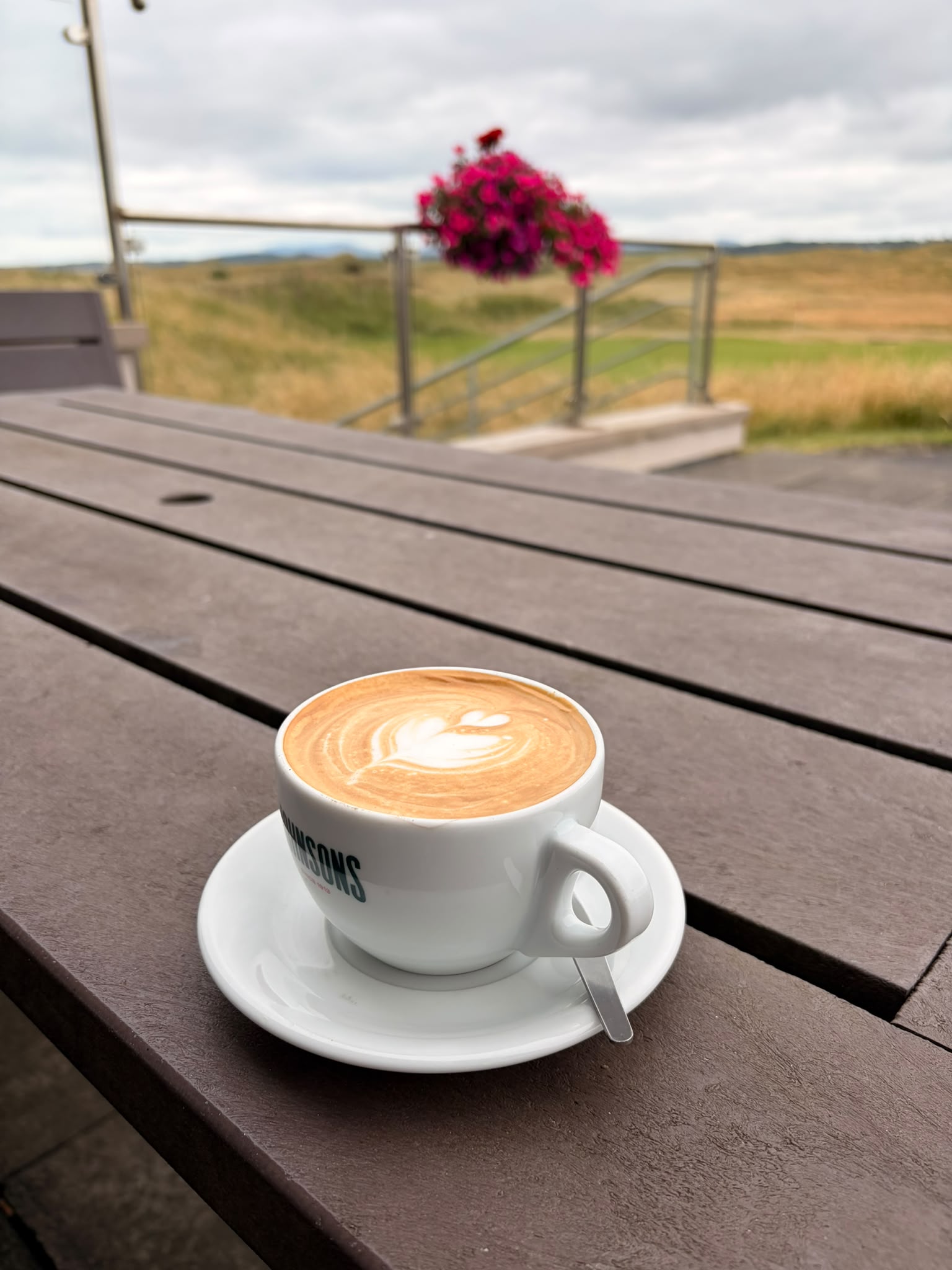 a fresh coffee on a wooden table outdoors of the donegal golf club restaurant